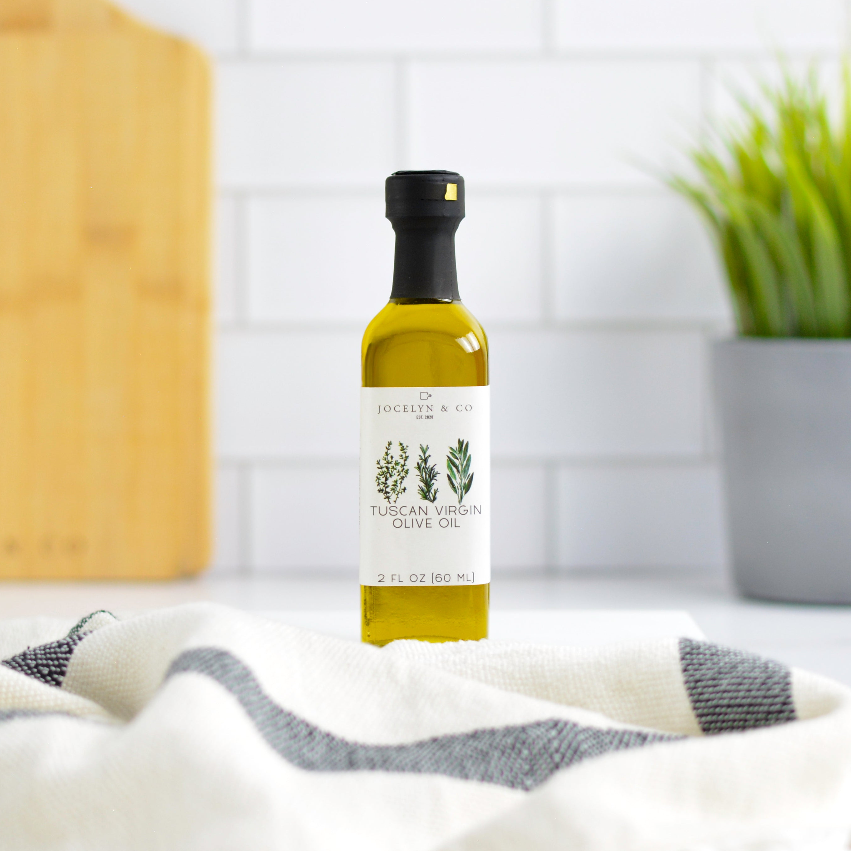 Bottle of Tuscan Virgin Olive Oil on a kitchen counter with a blurred background